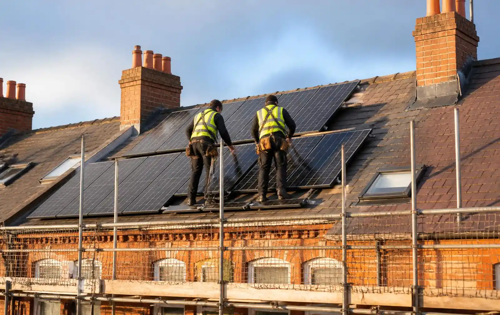 Illustrative image of solar panels being fitted to a slate roof
